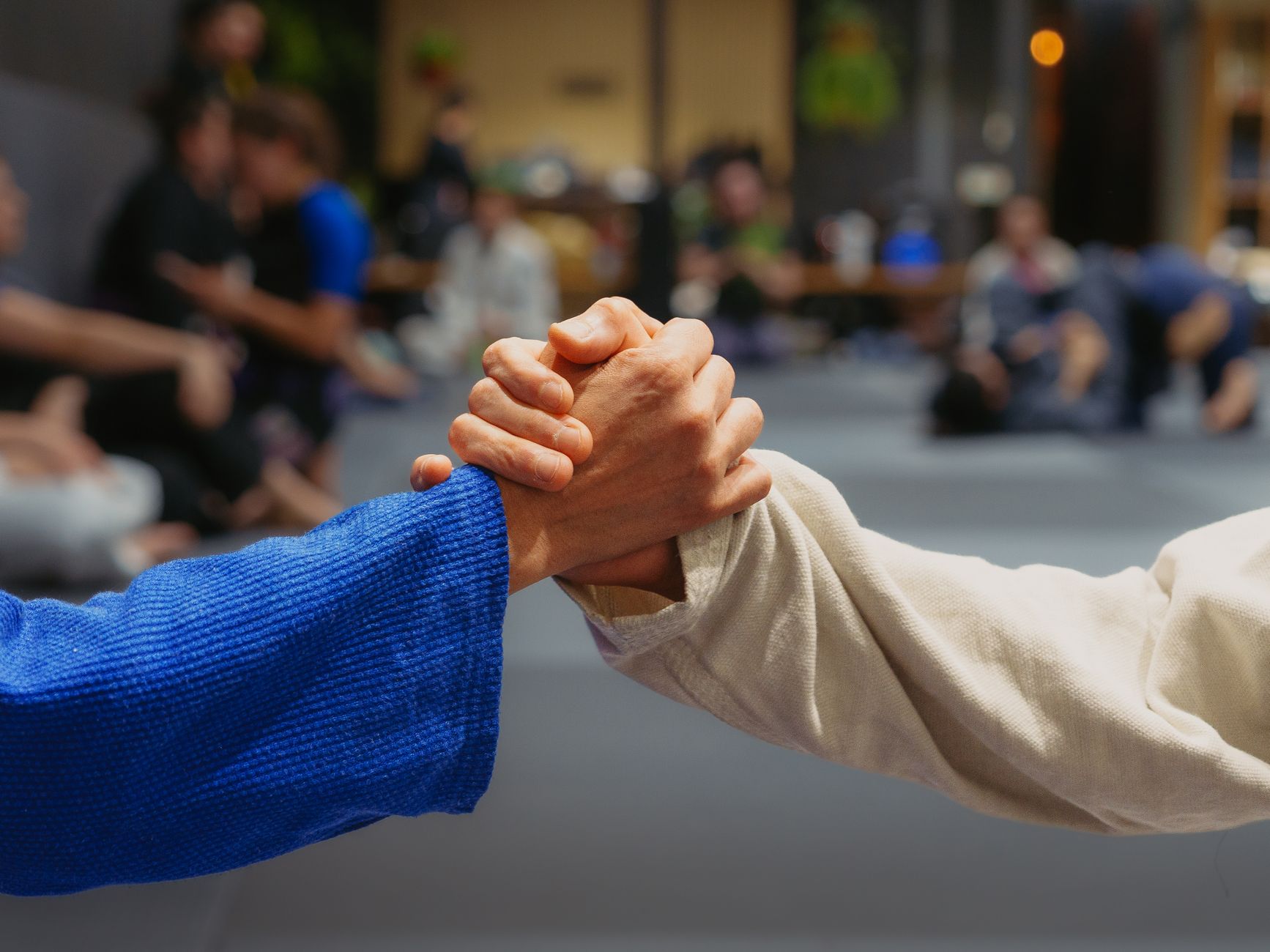 Two athletes grappling in a Brazilian Jiu Jitsu match