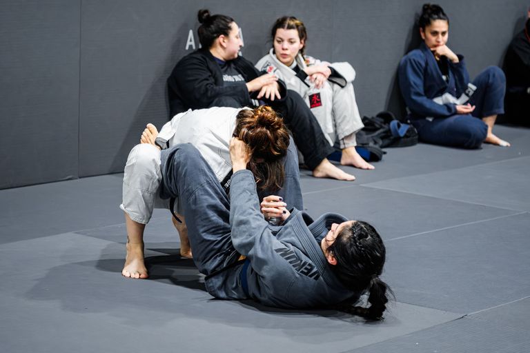 Two athletes competing in a Brazilian Jiu Jitsu match