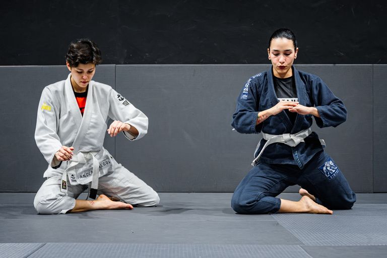 Two athletes competing in a Brazilian Jiu Jitsu match