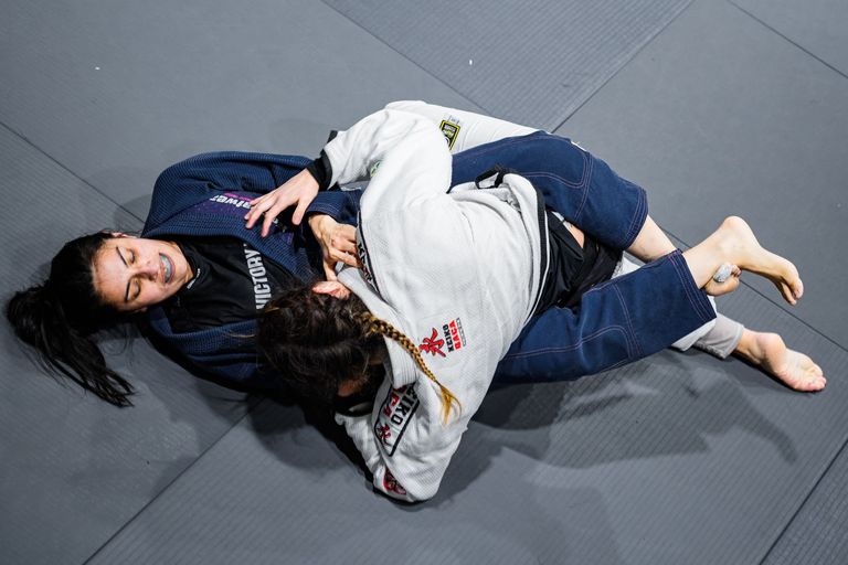Two athletes competing in a Brazilian Jiu Jitsu match