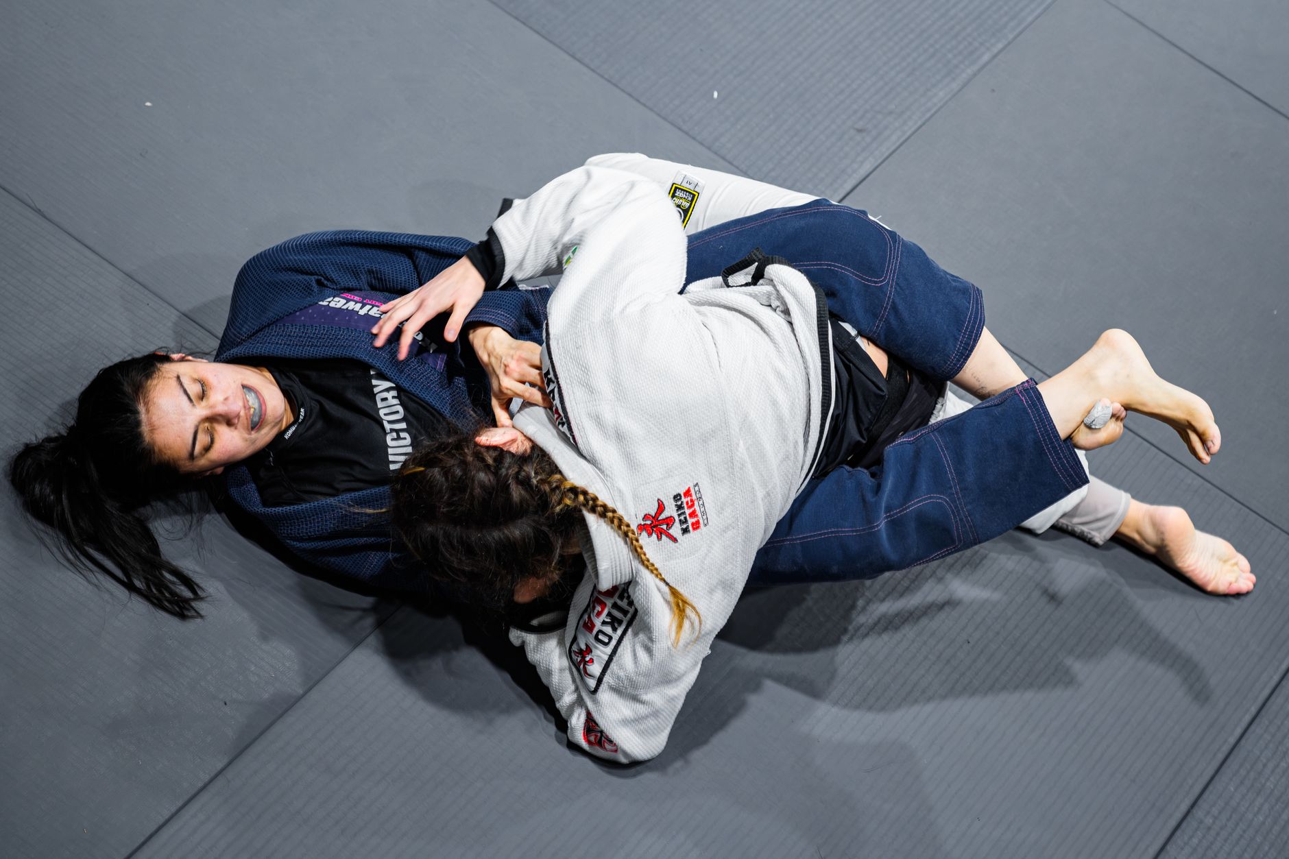 Two athletes competing in a Brazilian Jiu Jitsu match