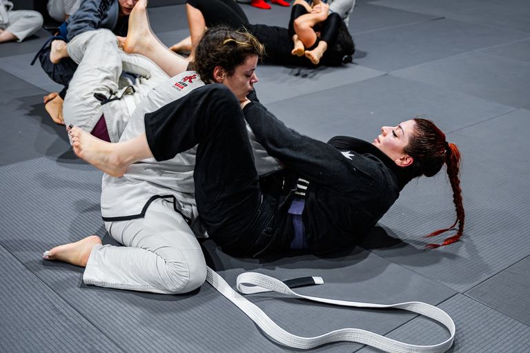 Athletes training Brazilian Jiu Jitsu on the mat