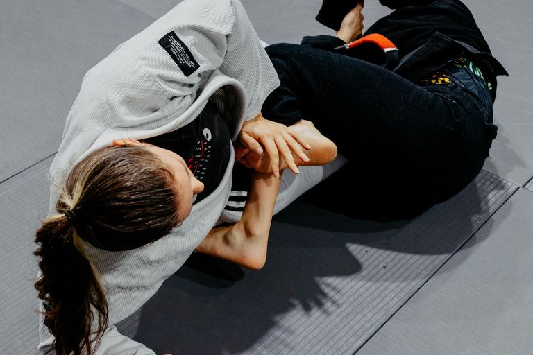 Two athletes competing in a Brazilian Jiu Jitsu match