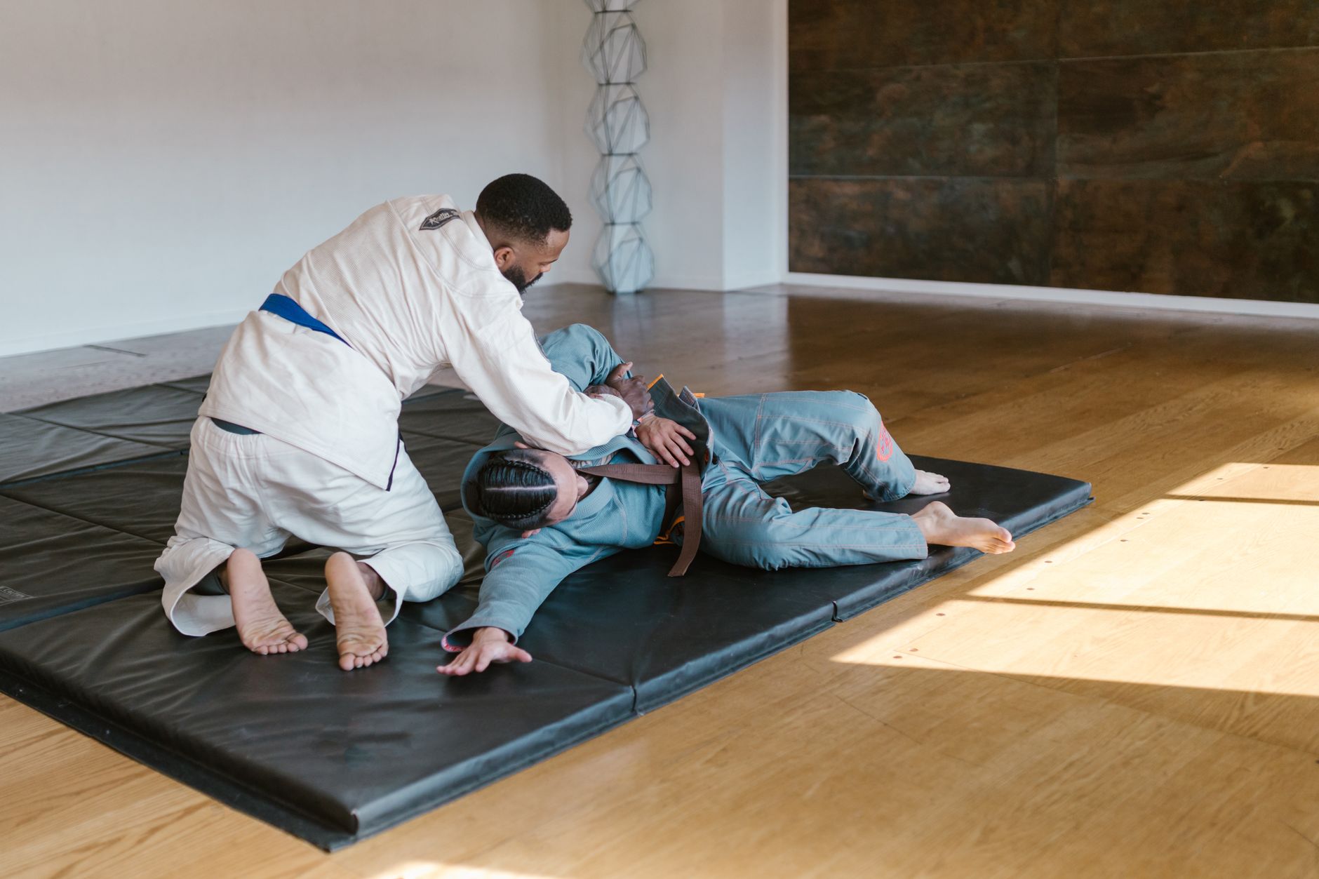 Two athletes competing in a Brazilian Jiu Jitsu match