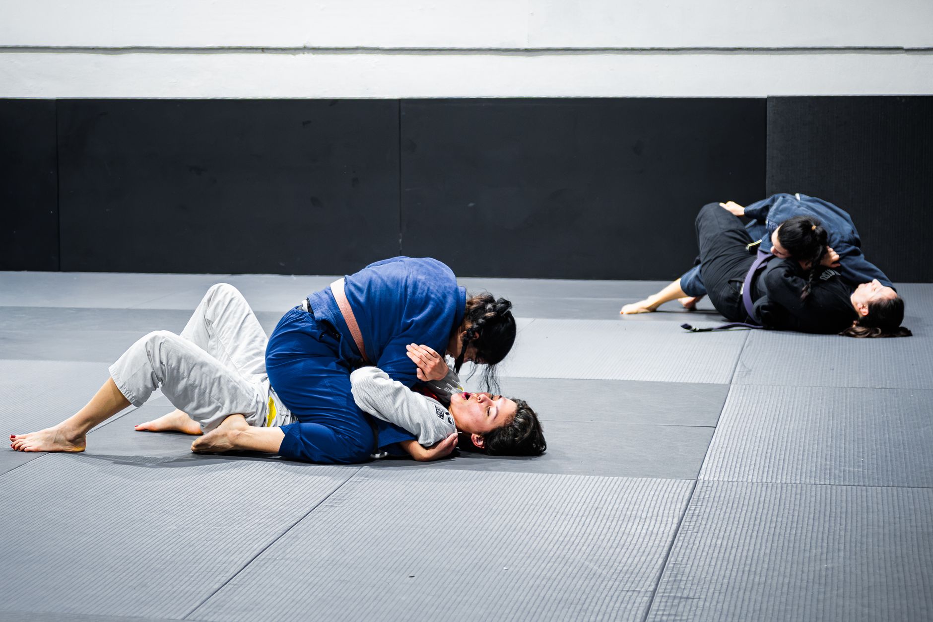 Two athletes competing in a Brazilian Jiu Jitsu match