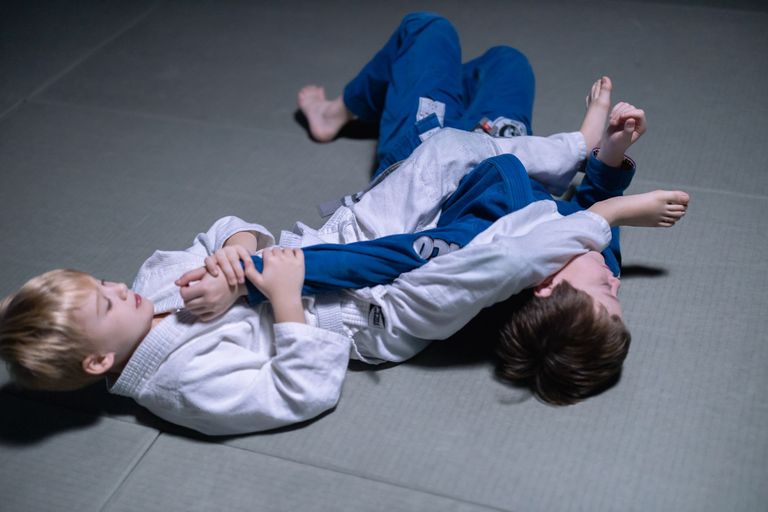 Athletes training Brazilian Jiu Jitsu on the mat