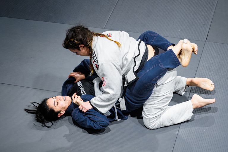 Two athletes competing in a Brazilian Jiu Jitsu match