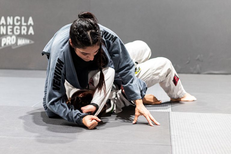 Two athletes competing in a Brazilian Jiu Jitsu match