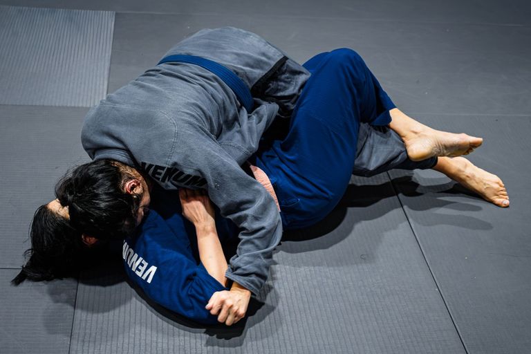 Two athletes competing in a Brazilian Jiu Jitsu match