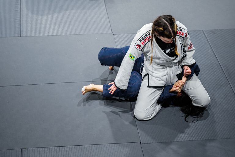 Two athletes competing in a Brazilian Jiu Jitsu match