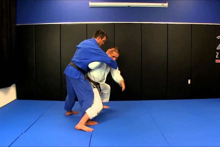 Travis Stevens executing a tai otoshi throw in the gi